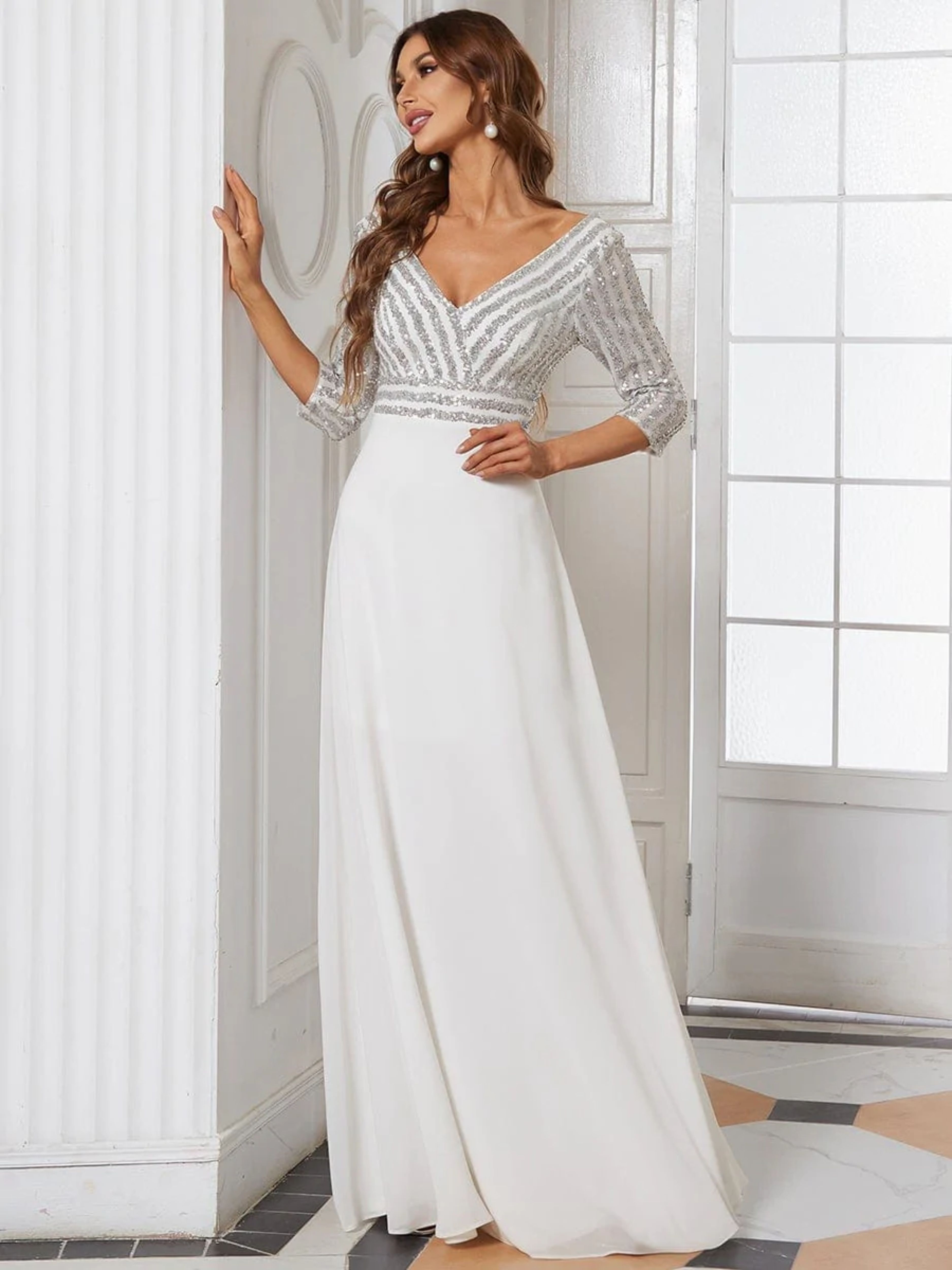 FEATURING A DOUBLE DEEP V NECKLINE, LONG SLEEVES AND A FLOWY A-LINE SKIRT.