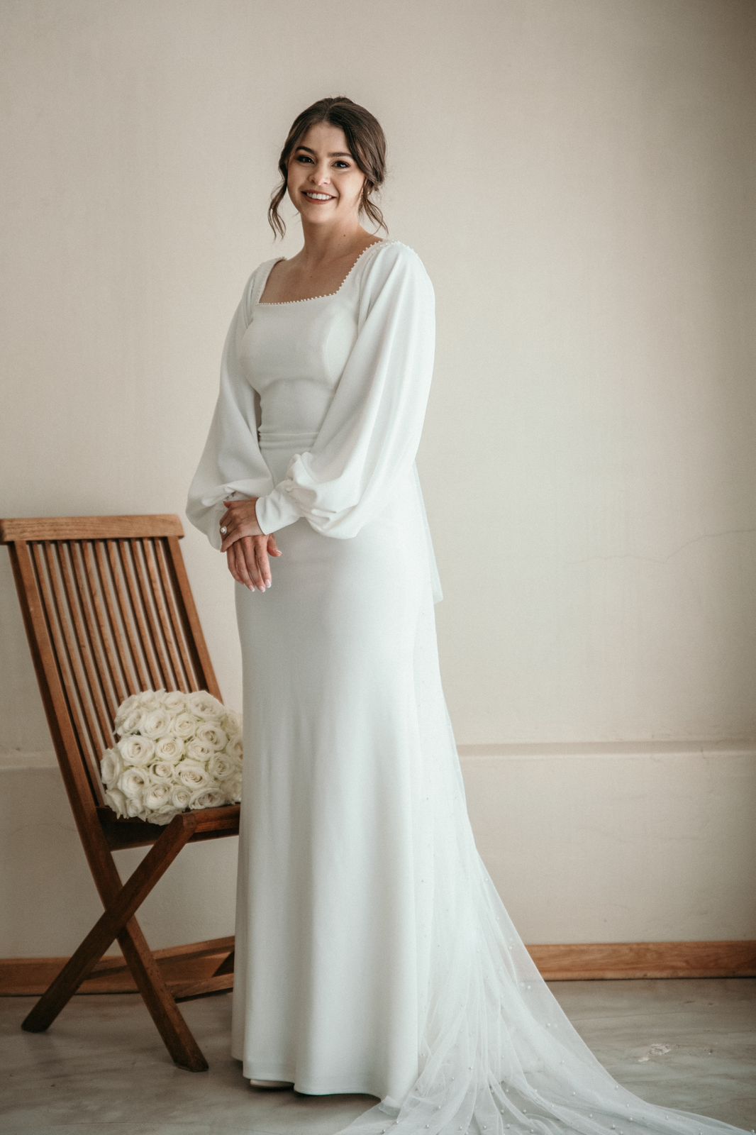 SIAN - A mermaid-style bridal gown made of crepe, showcasing a square neckline and elegant bishop sleeves.
