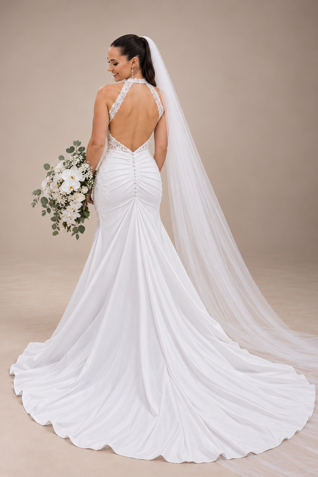 JOLENE A timeless mermaid wedding dress featuring a beautifully detailed lace bodice with a deep illusion V-neckline and delicate beaded straps. The sleek fitted silhouette flows effortlessly into a soft flared skirt and graceful lace-edged train