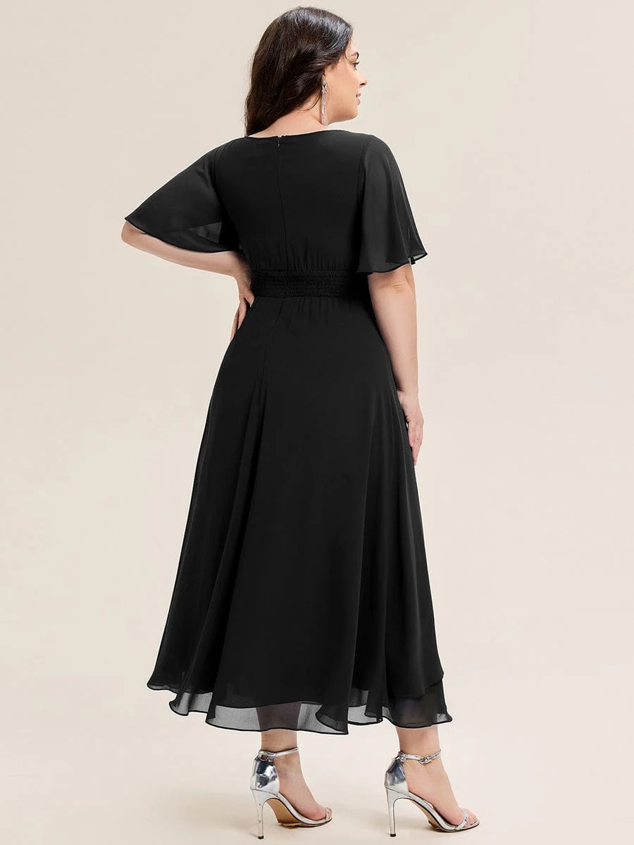 Lilou A beautifully pleated chiffon midi dress designed for plus-size elegance, featuring soft ruffle sleeves and a flattering flowy silhouette — perfect for any special celebration.  This dress is not currently in stock but is available to order.