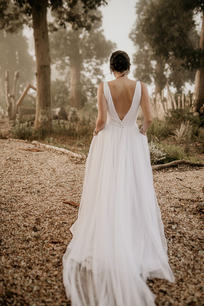 Angelique White V Neckline Crepe A-line Wedding dress with a detachable tulle skirt. Low back bodice. Pockets.