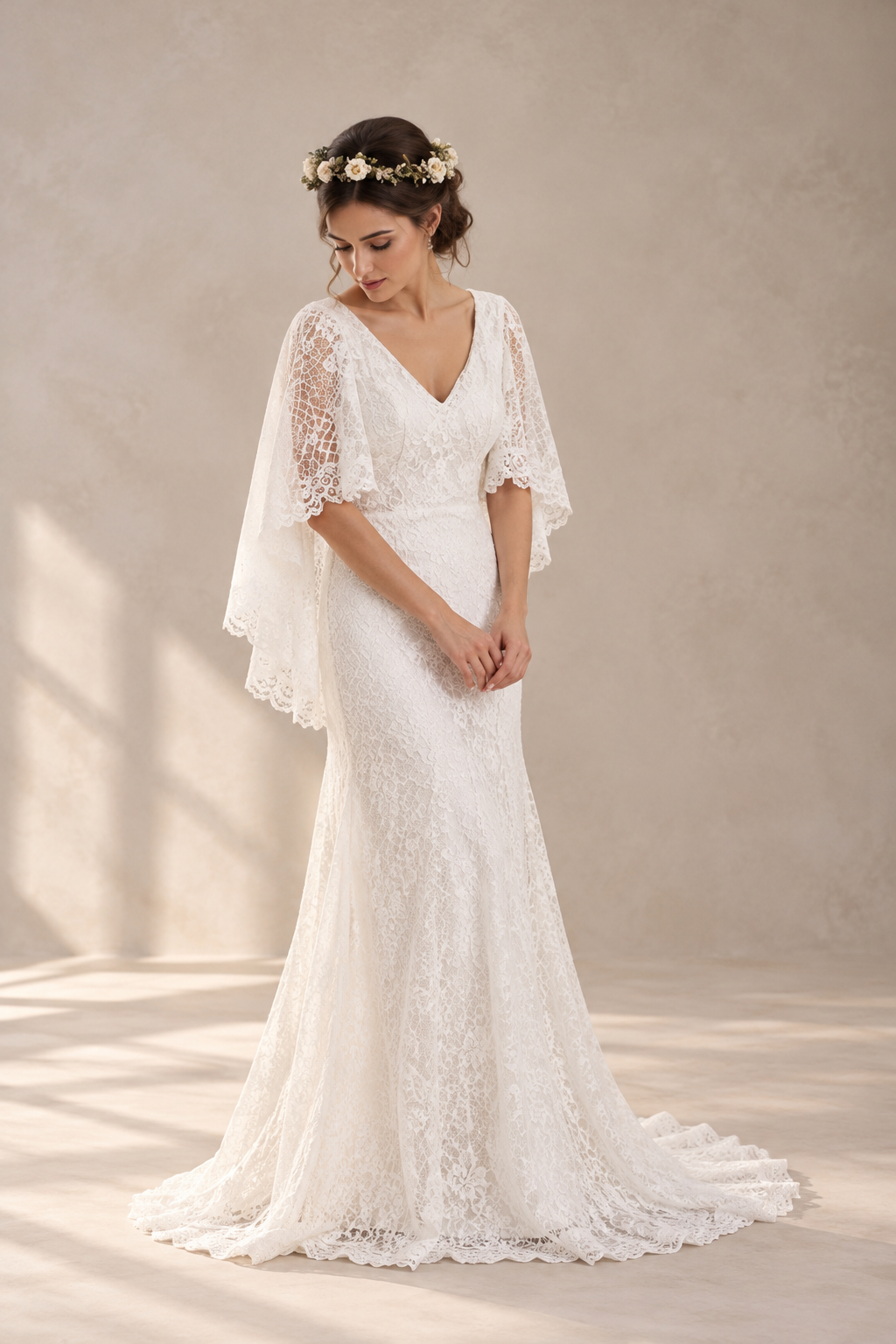 JOLENE A timeless mermaid wedding dress featuring a beautifully detailed lace bodice with a deep illusion V-neckline and delicate beaded straps. The sleek fitted silhouette flows effortlessly into a soft flared skirt and graceful lace-edged train