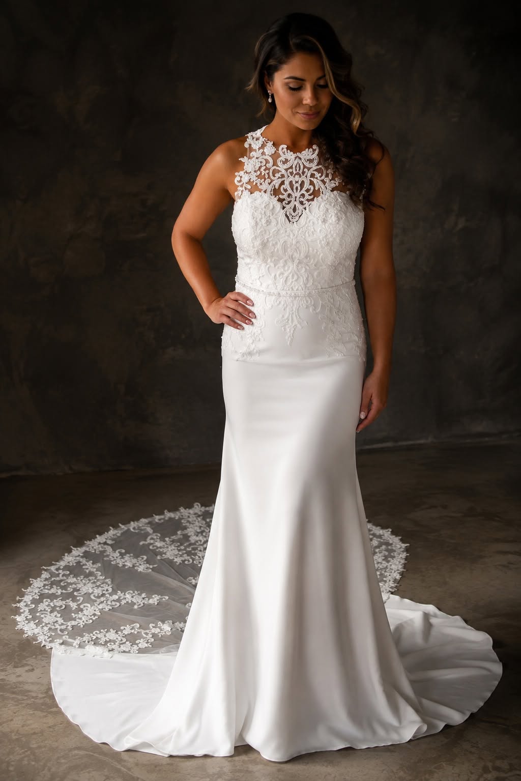 calpurnia Elegant off-white crepe and lace wedding dress with an illusion lace bodice and statement lace train.