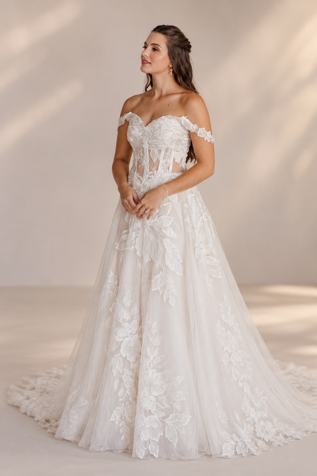 JOLENE A timeless mermaid wedding dress featuring a beautifully detailed lace bodice with a deep illusion V-neckline and delicate beaded straps. The sleek fitted silhouette flows effortlessly into a soft flared skirt and graceful lace-edged train