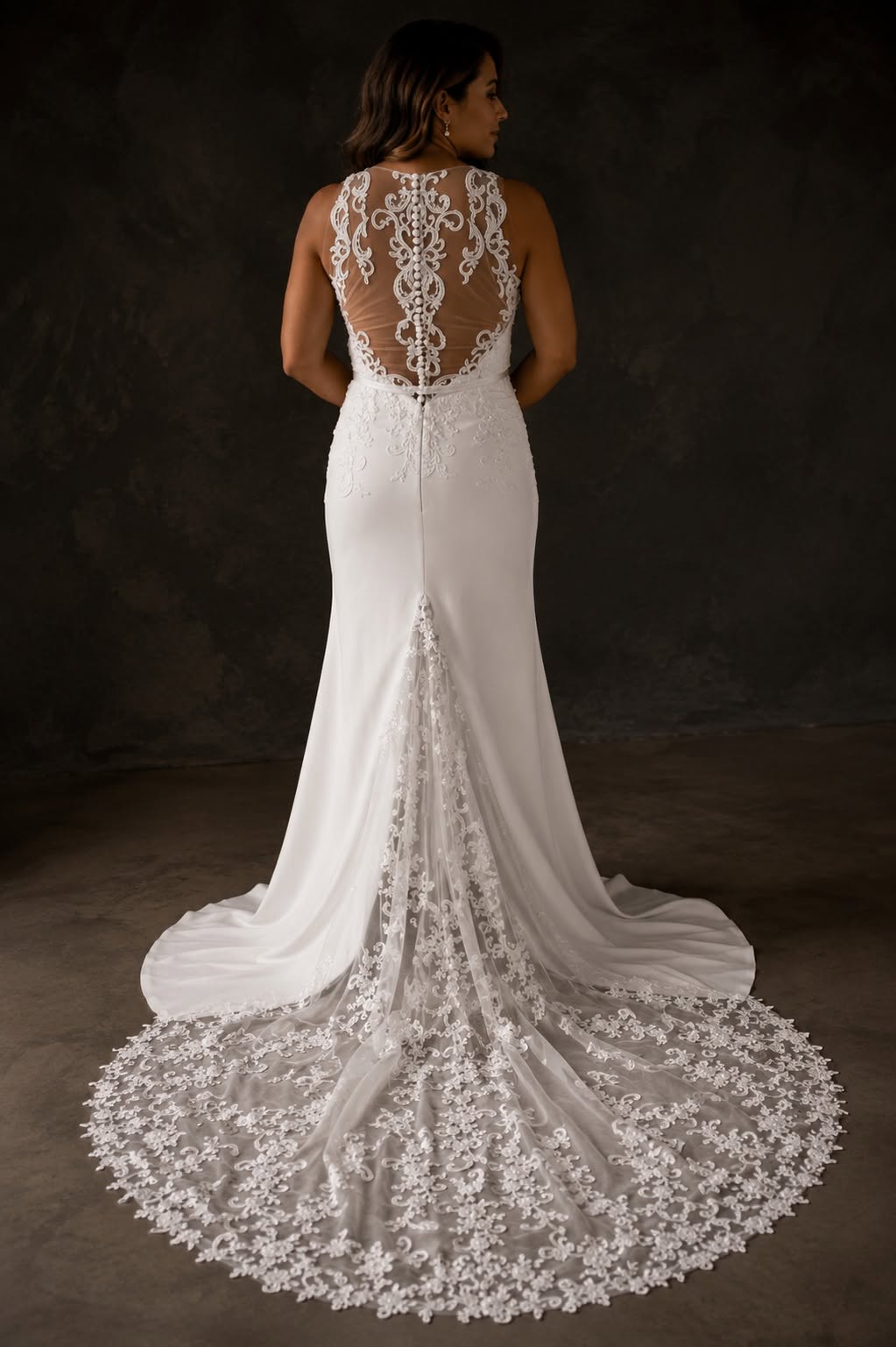 calpurnia Elegant off-white crepe and lace wedding dress with an illusion lace bodice and statement lace train.