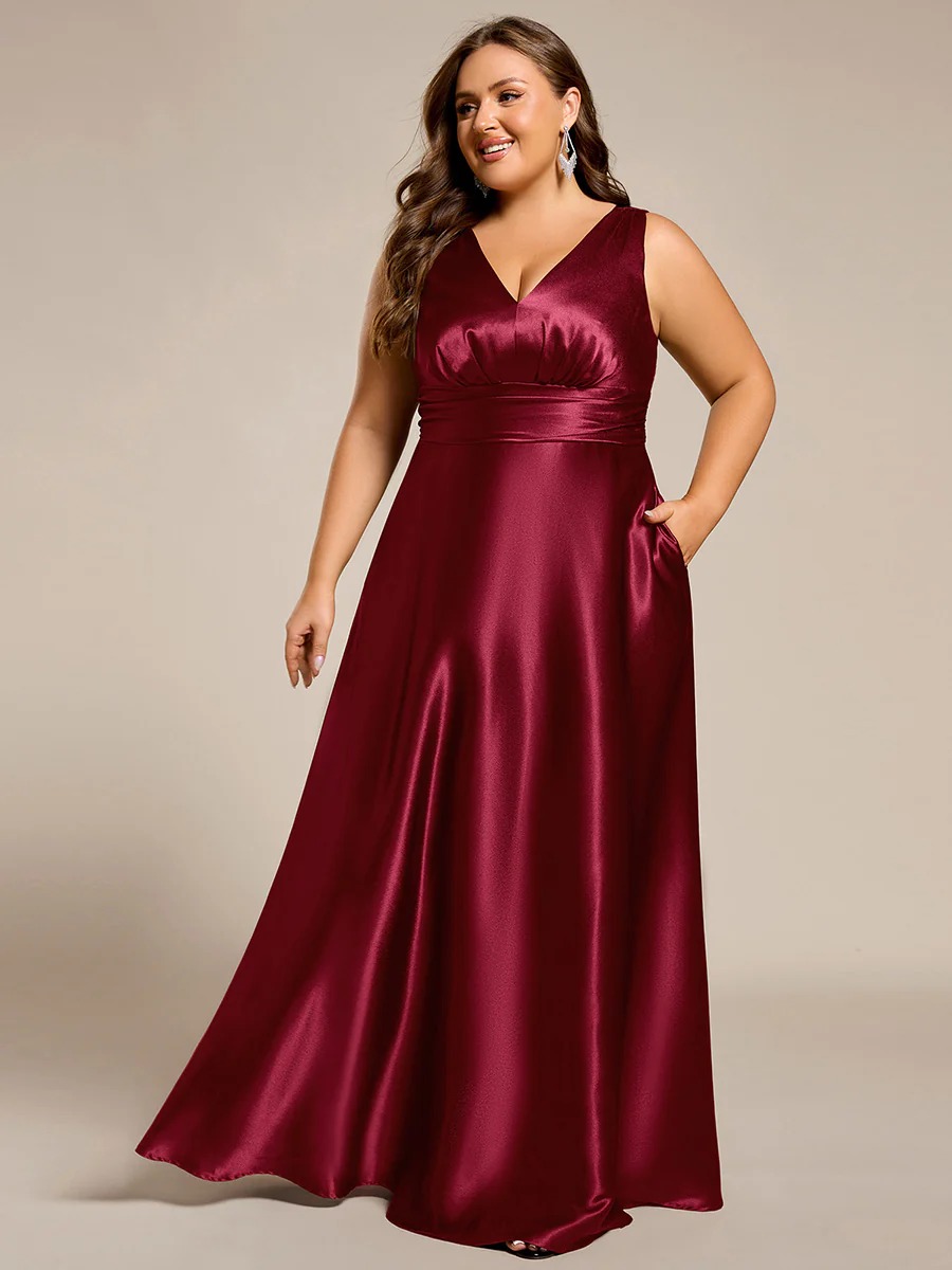 This plus-size satin maxi bridesmaid dress offers a blend of comfort and elegance. The empire waist design flatters every figure, while the soft satin fabric creates a smooth, luxurious look. Convenient side pockets add a practical touch, making it perfect for weddings and formal events where both style and functionality are key.