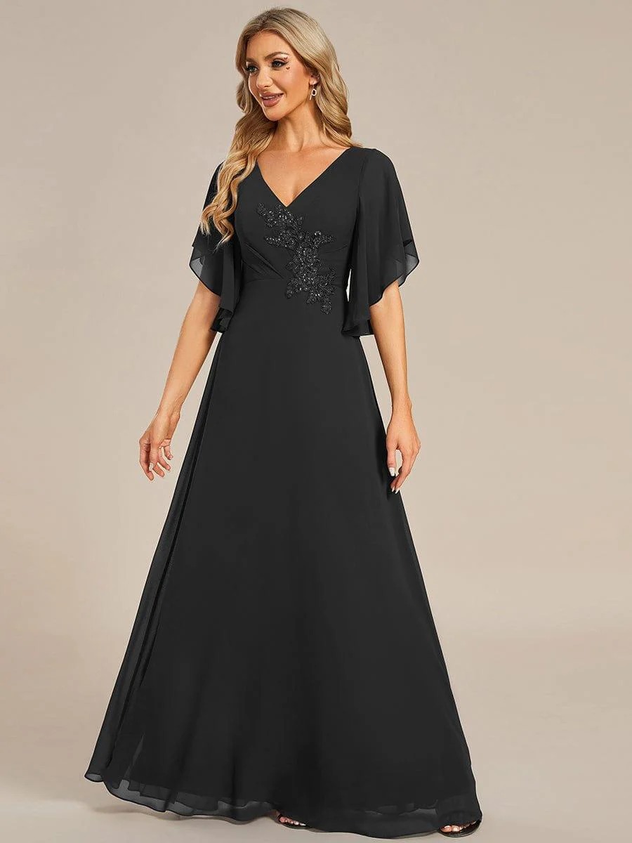 Lorie A graceful chiffon Mother of the Bride dress featuring elegant half sleeves and beautifully placed appliqué detailing on the bodice for a refined and feminine finish.  This dress is not currently in stock but is available to order.