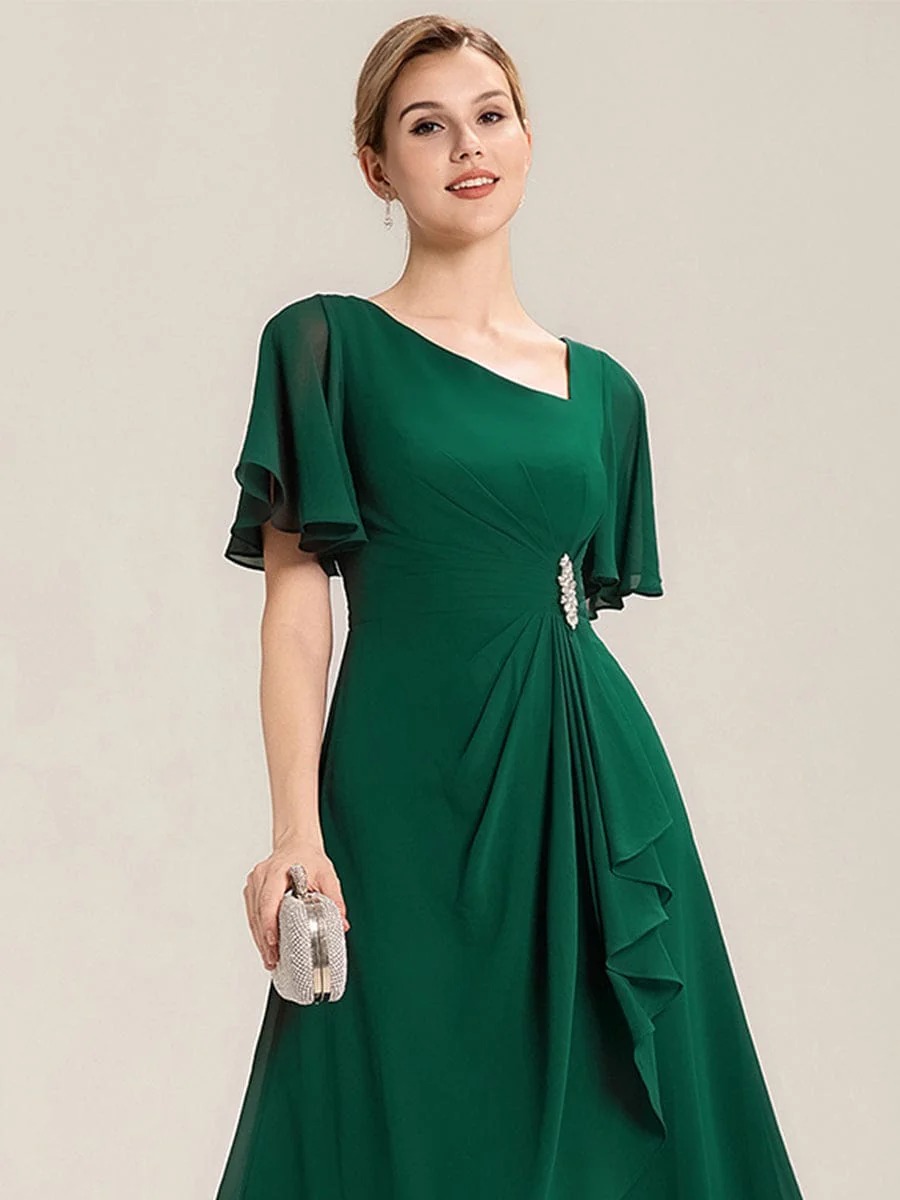 Lilou A beautifully pleated chiffon midi dress designed for plus-size elegance, featuring soft ruffle sleeves and a flattering flowy silhouette — perfect for any special celebration.  This dress is not currently in stock but is available to order.