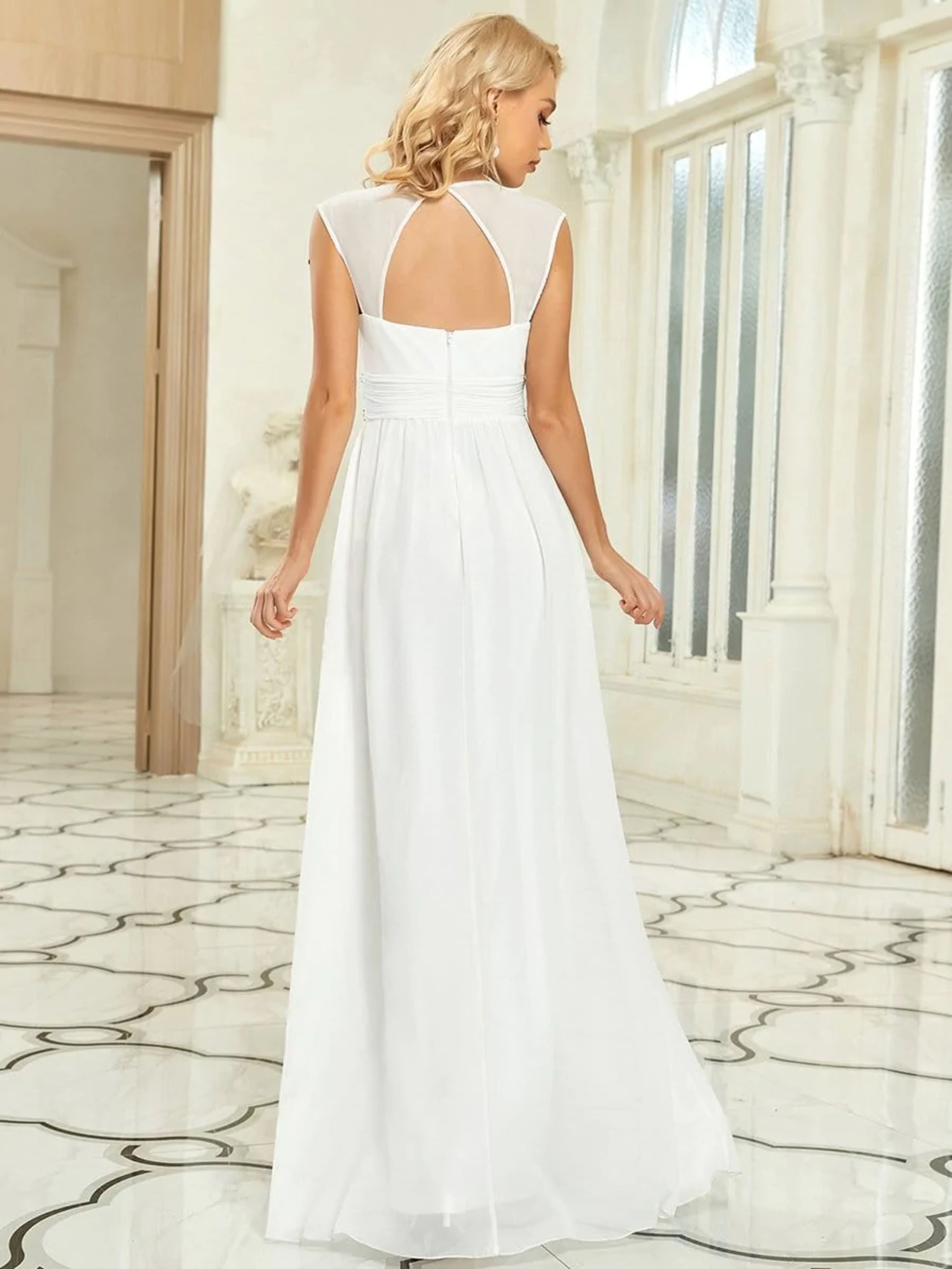 CHIFFON WEDDING DRESS WITH DECORATIVE BEADED DETAIL ON THE WAIST. THE PLUNGING V-NECK AND CAPPED SLEEVELESS TOP FEATURE FLATTERING RUCHING THROUGHOUT, ALONG WITH A FLOWING A-LINE SILHOUETTE.