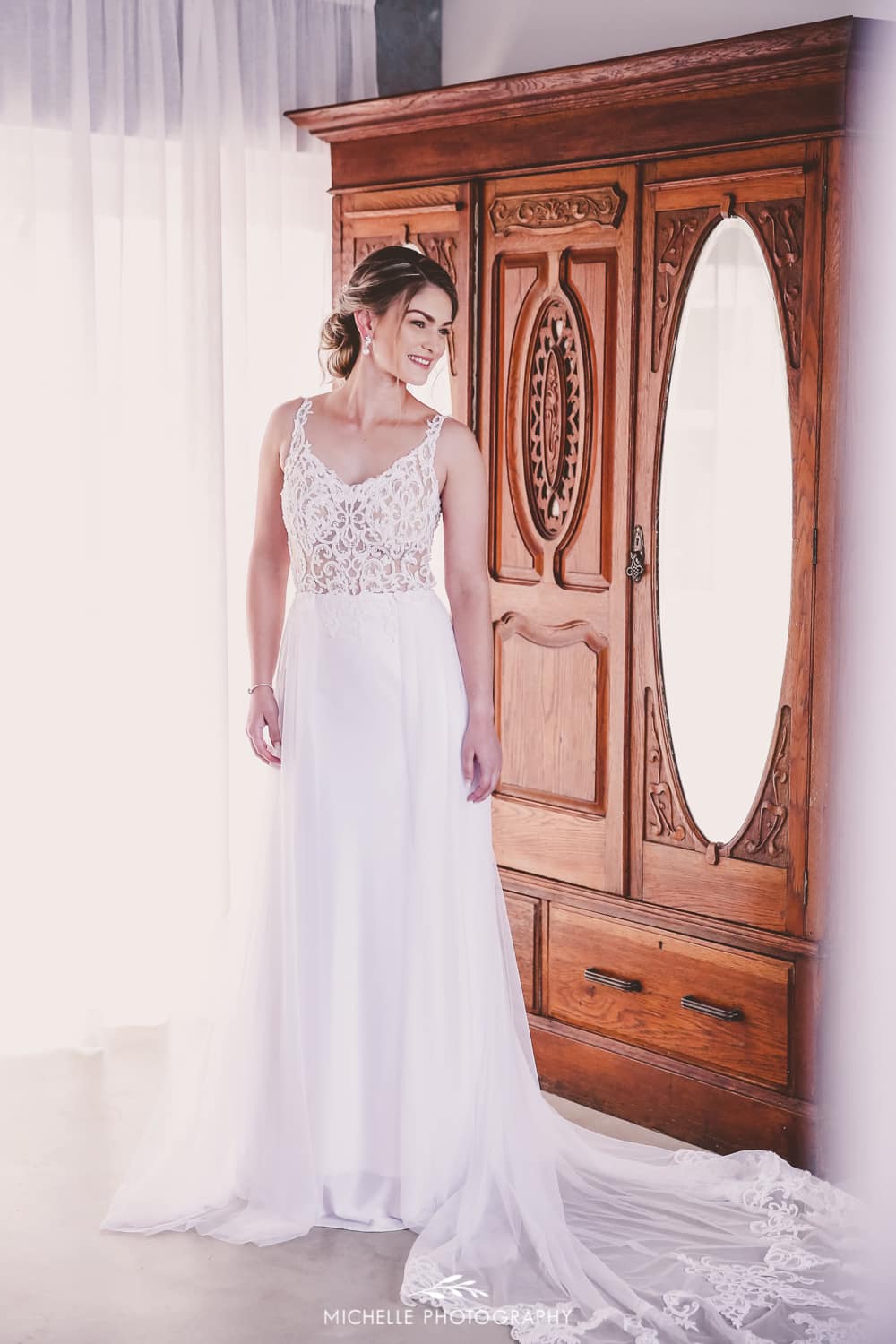 MICAELA - A sheer bodice adorned with delicate beaded lace and a sweetheart V-neckline, paired with a sleek crepe sheath skirt.
