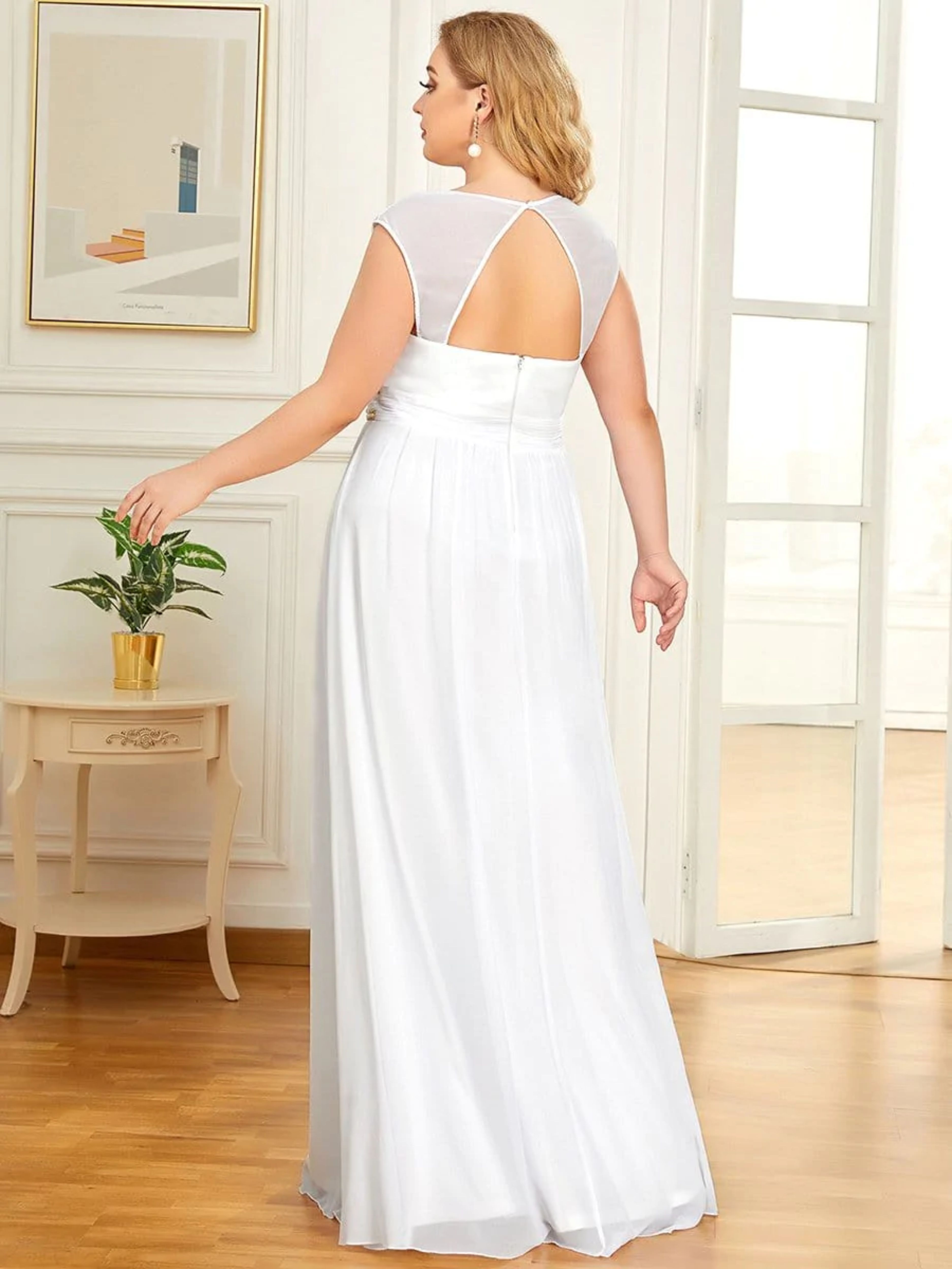 CHIFFON WEDDING DRESS WITH DECORATIVE BEADED DETAIL ON THE WAIST. THE PLUNGING V-NECK AND CAPPED SLEEVELESS TOP FEATURE FLATTERING RUCHING THROUGHOUT, ALONG WITH A FLOWING A-LINE SILHOUETTE.
