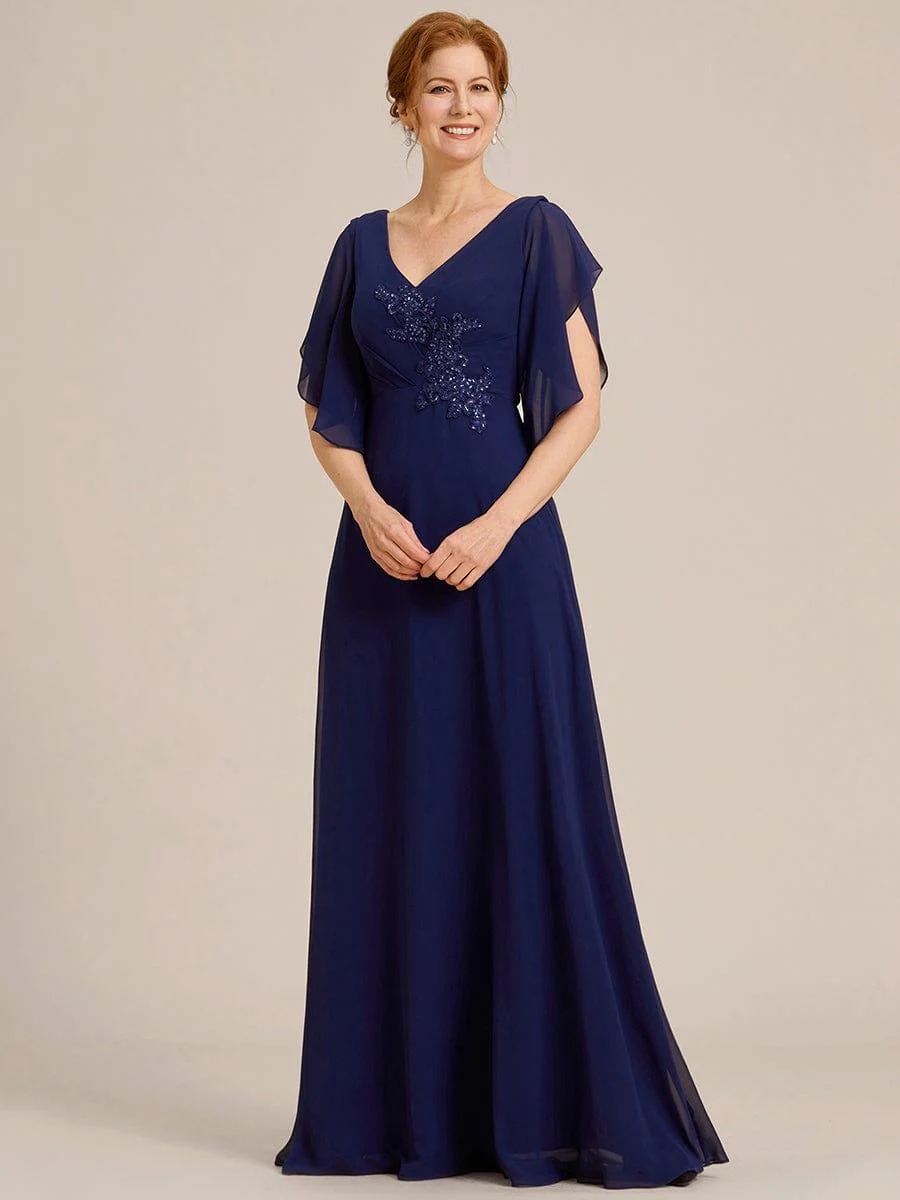 Lorie A graceful chiffon Mother of the Bride dress featuring elegant half sleeves and beautifully placed appliqué detailing on the bodice for a refined and feminine finish.  This dress is not currently in stock but is available to order.