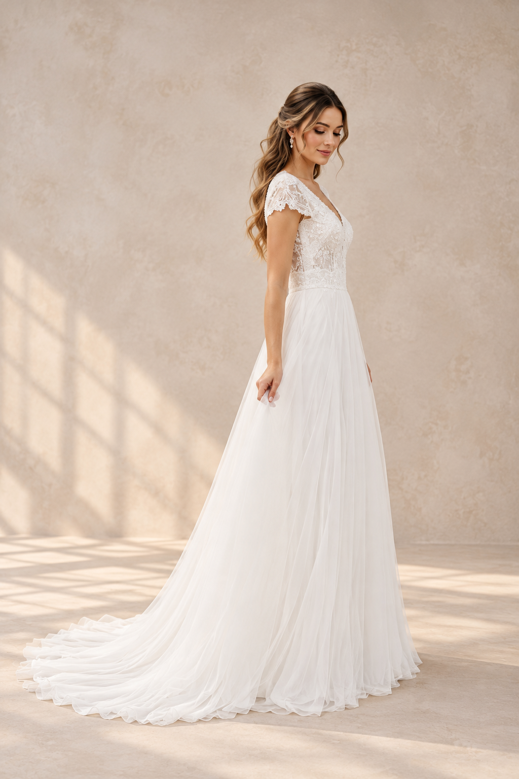 JOLENE A timeless mermaid wedding dress featuring a beautifully detailed lace bodice with a deep illusion V-neckline and delicate beaded straps. The sleek fitted silhouette flows effortlessly into a soft flared skirt and graceful lace-edged train
