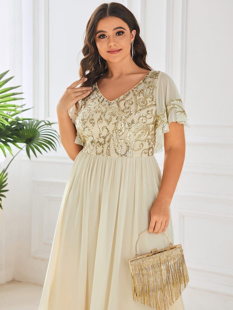 Hazel A sophisticated Mother of the Bride dress featuring a sparkling sequin V-neck bodice, soft short sleeves, and a smooth, flowing skirt for timeless elegance.  This dress is not currently in stock but is available to order.
