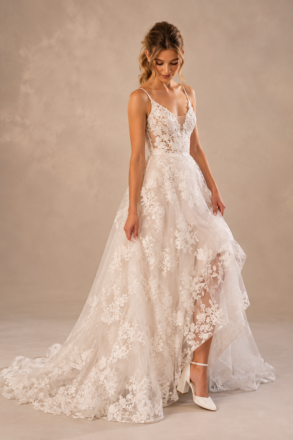 JOLENE A timeless mermaid wedding dress featuring a beautifully detailed lace bodice with a deep illusion V-neckline and delicate beaded straps. The sleek fitted silhouette flows effortlessly into a soft flared skirt and graceful lace-edged train