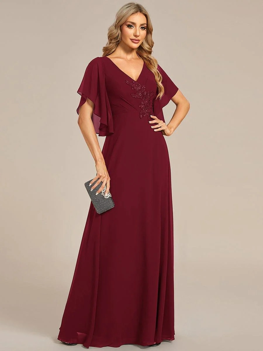 Lorie A graceful chiffon Mother of the Bride dress featuring elegant half sleeves and beautifully placed appliqué detailing on the bodice for a refined and feminine finish.  This dress is not currently in stock but is available to order.